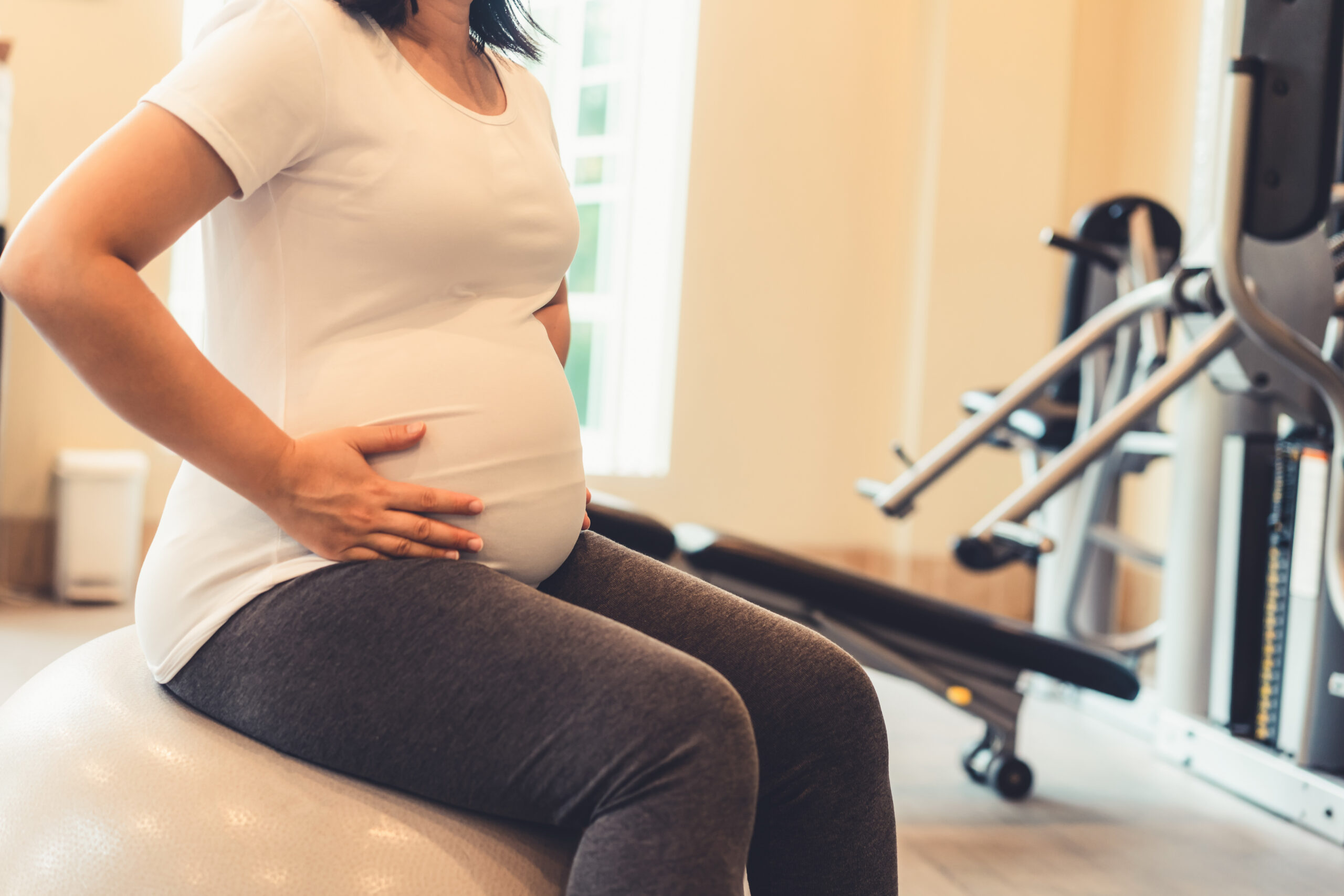 Mom using special cushion for prenatal chiropractic care during pregnancy.