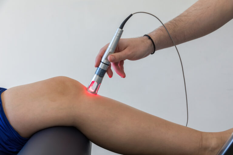 Cold laser therapy being applied to patient’s lower back at Ortman Chiropractic